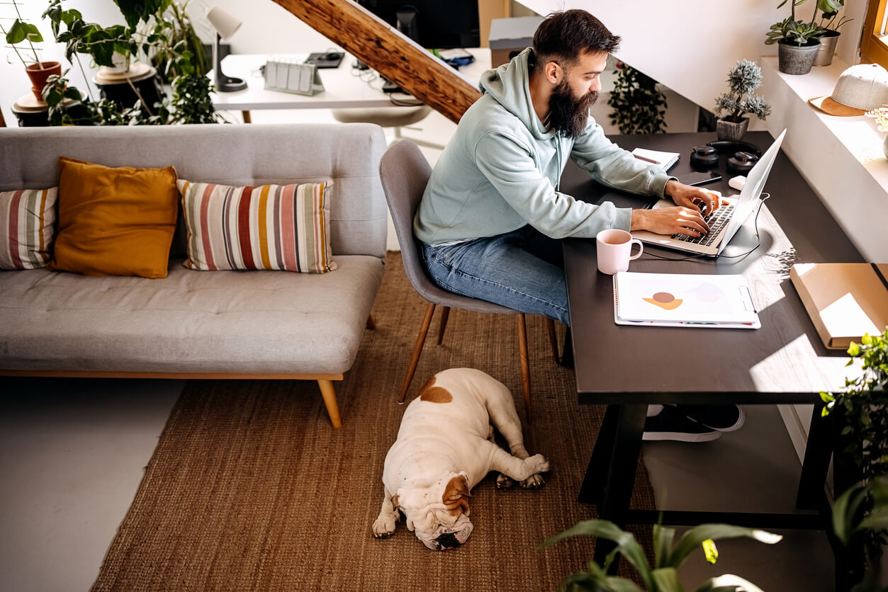 Man working at home in compliance with a hybrid work policy