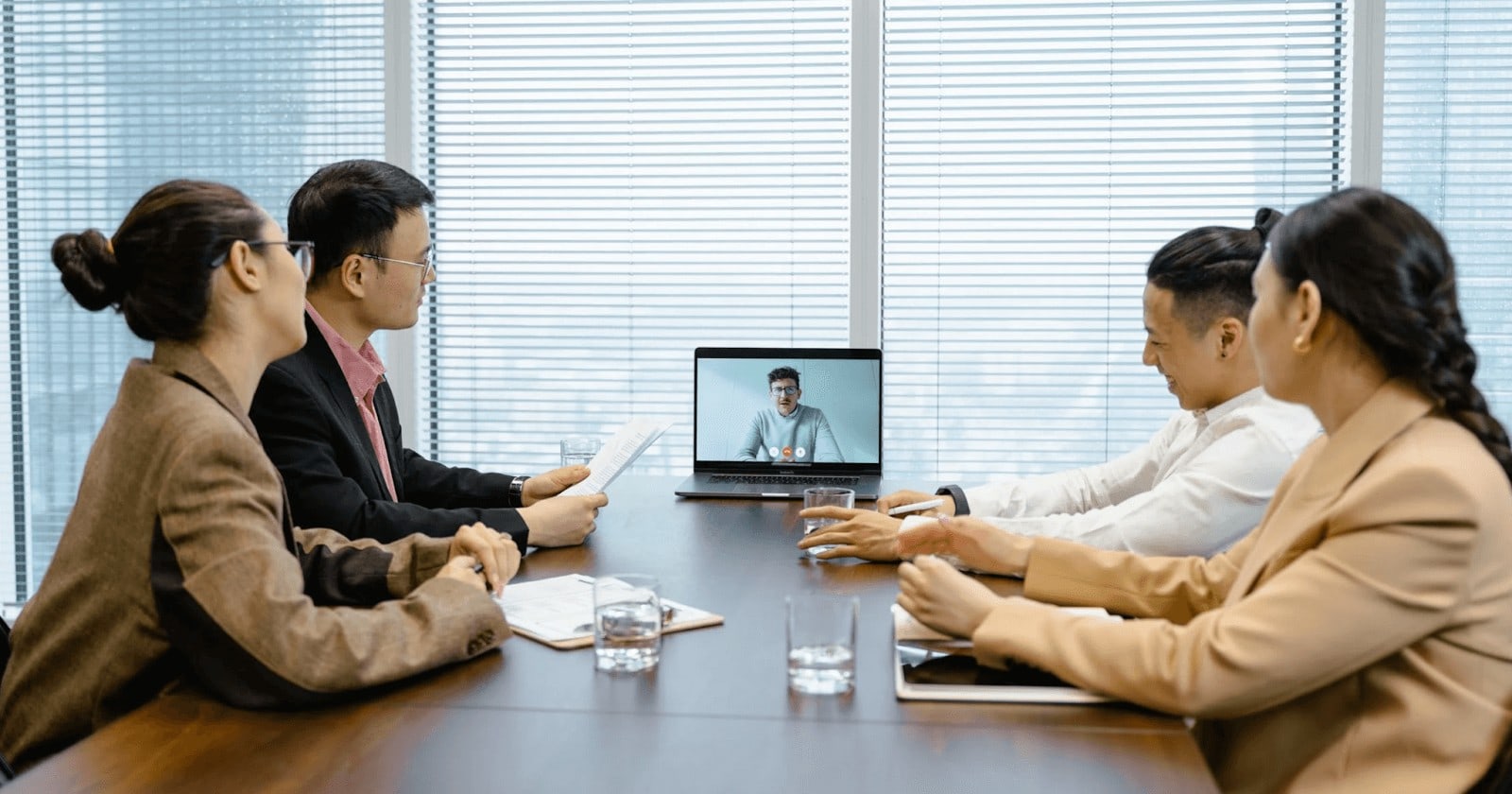 Outsourced employees have a virtual meeting with team members