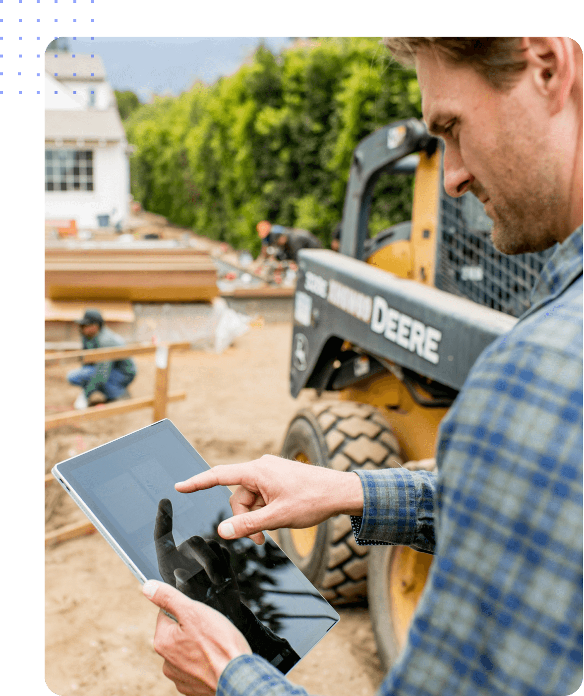 A field service manager exploring Hubstaff workforce productivity features on a tablet at a job site